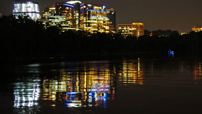 River water reflecting city lights at night